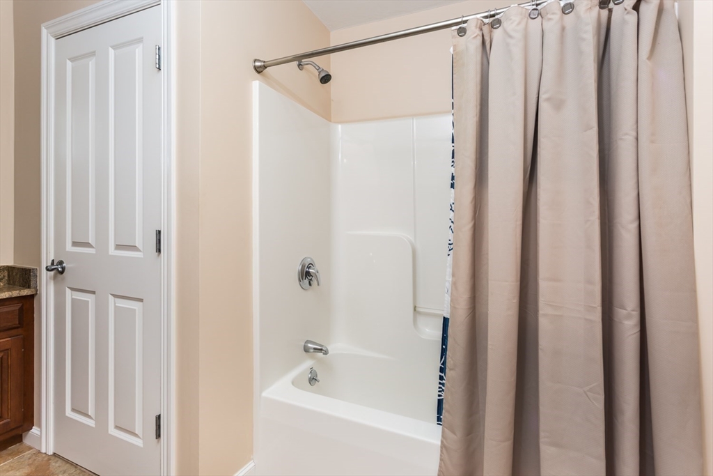 49 Beaver Street, Unit 49 Franklin, MA 02038 - Photo 23 of 46 a bathroom with a shower and a tub