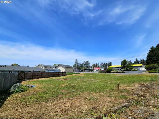 a view of a big yard with a city view