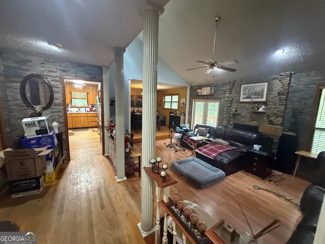 a living room with furniture and a wooden floor