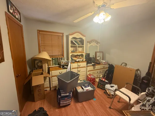 a view of a workspace with furniture window and wooden floor