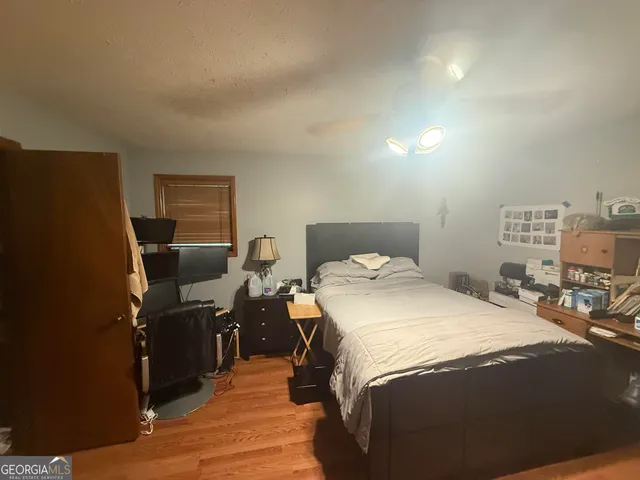 a bedroom with a bed and desk chair