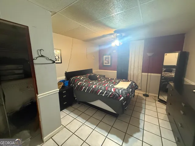 a bedroom with a bed and a mirror