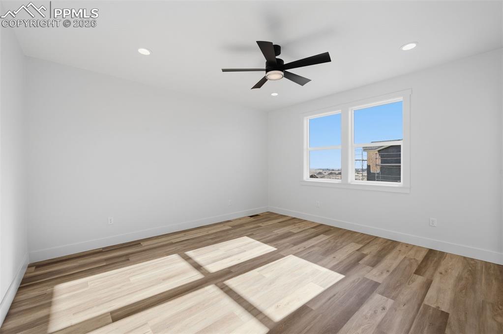 11293 Est Rdg Drive Peyton, CO 80831 - Photo 14 of 50 a view of empty room with wooden floor and fan