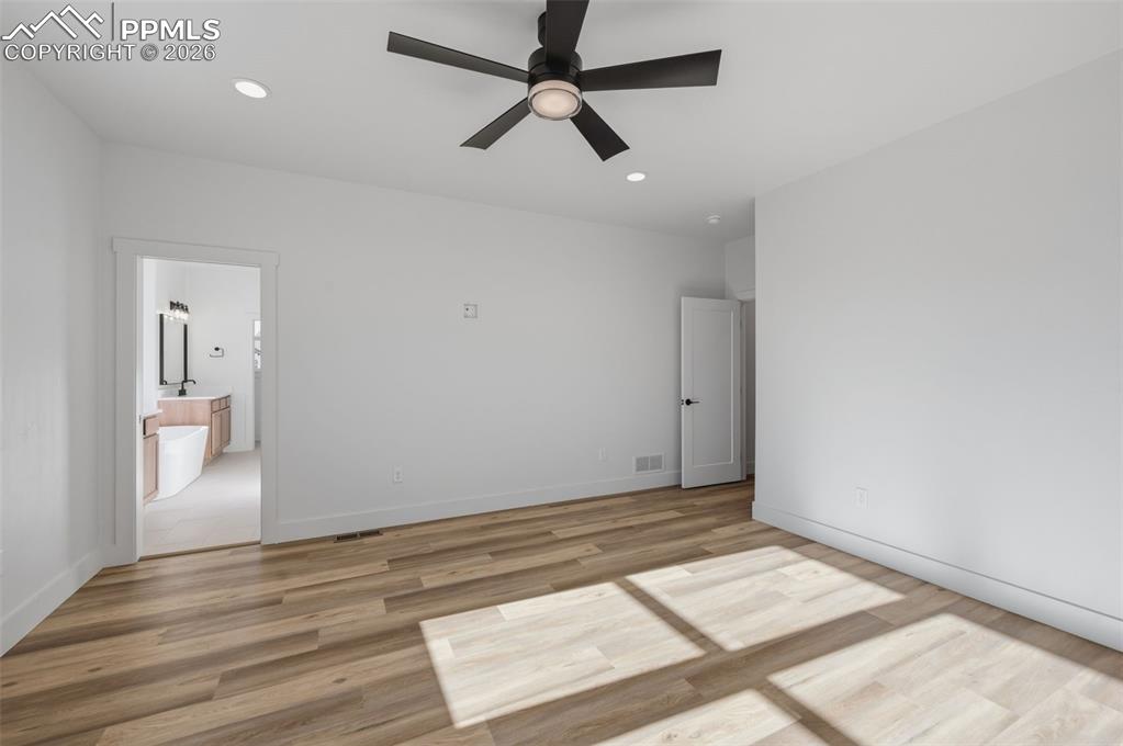 11293 Est Rdg Drive Peyton, CO 80831 - Photo 15 of 50 an empty room with wooden floor and windows