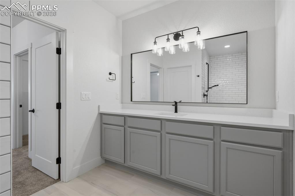 11293 Est Rdg Drive Peyton, CO 80831 - Photo 28 of 50 a bathroom with a double vanity sink and mirror