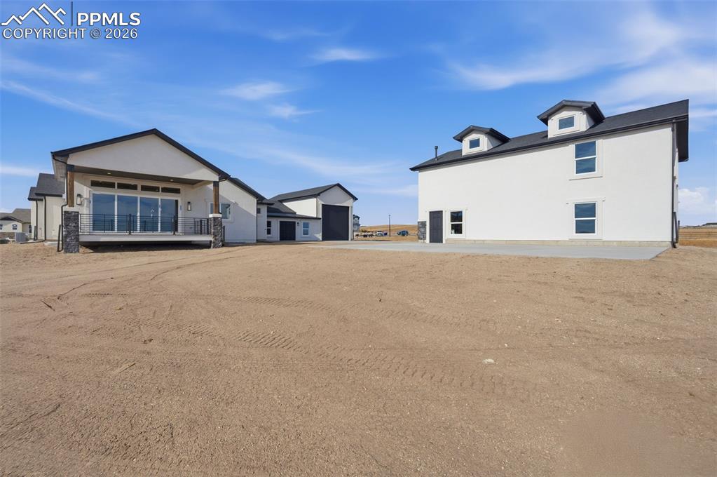 11293 Est Rdg Drive Peyton, CO 80831 - Photo 44 of 50 a view of a house with a yard and garage
