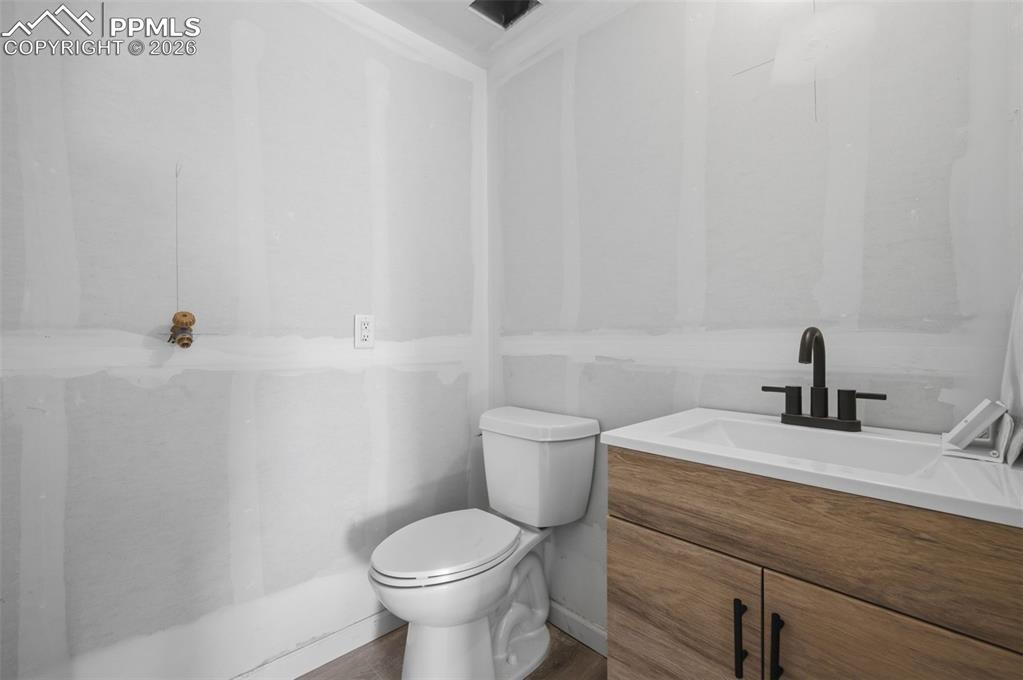 11293 Est Rdg Drive Peyton, CO 80831 - Photo 49 of 50 a bathroom with a granite countertop toilet and sink