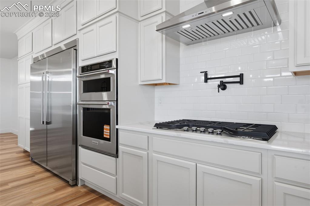 11293 Est Rdg Drive Peyton, CO 80831 - Photo 7 of 50 a kitchen with cabinets and appliances