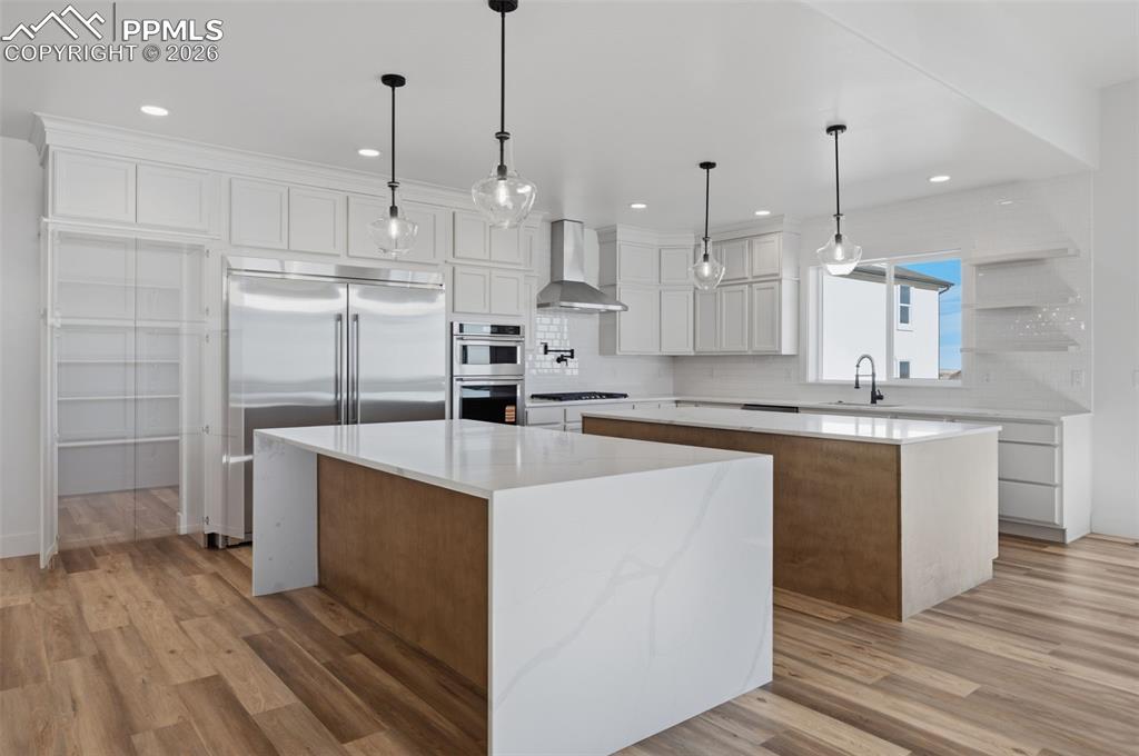 11293 Est Rdg Drive Peyton, CO 80831 - Photo 9 of 50 a kitchen with kitchen island a sink stainless steel appliances and cabinets