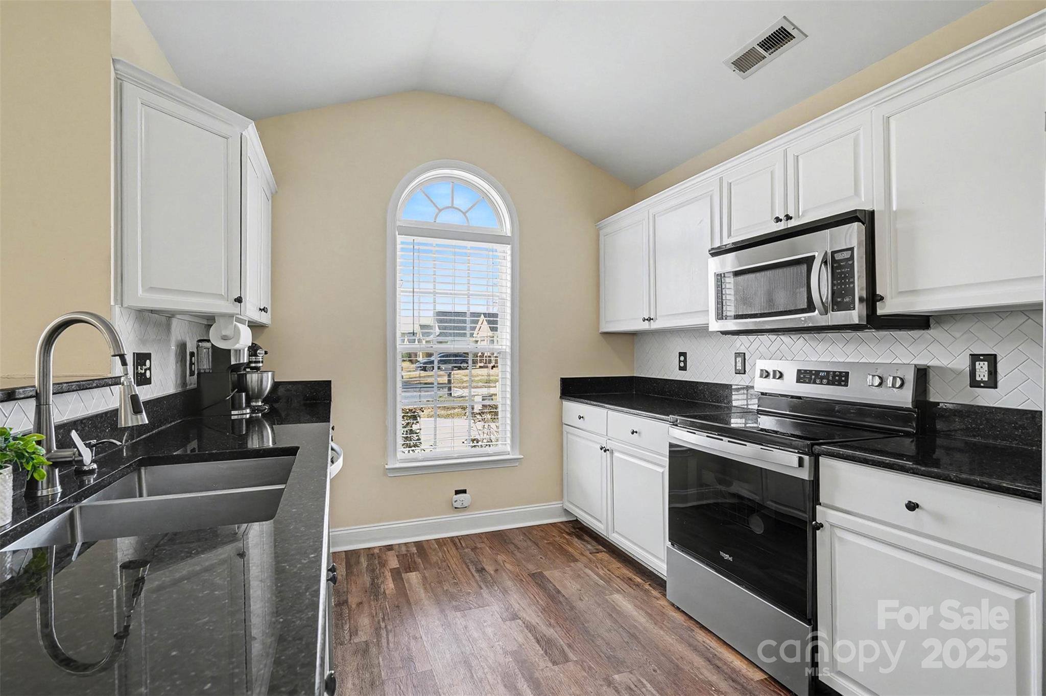 413 Dexter Place Monroe, NC 28110 - Photo 14 of 32 a kitchen with stainless steel appliances granite countertop a stove a sink and a microwave