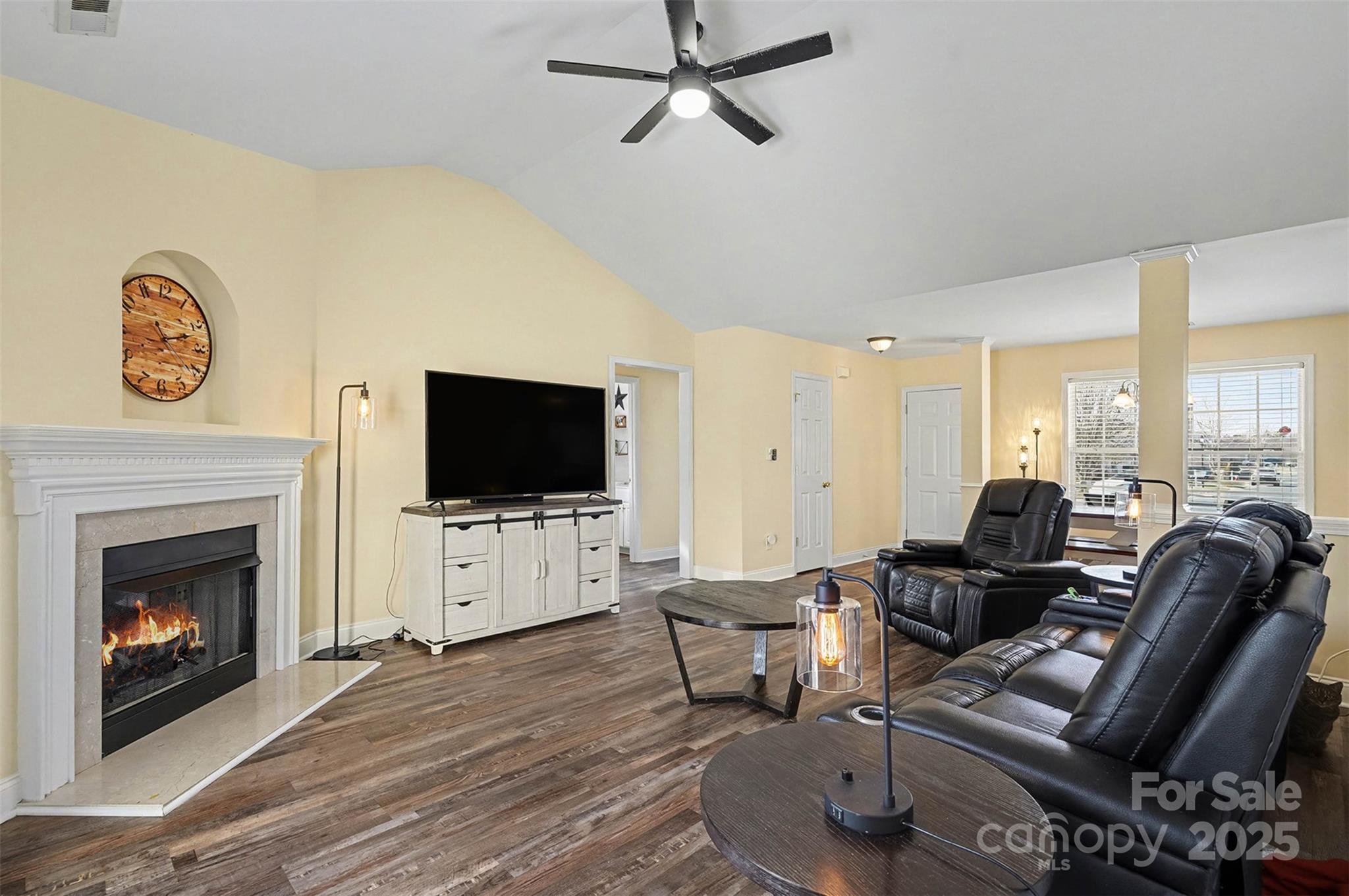 413 Dexter Place Monroe, NC 28110 - Photo 5 of 32 a living room with furniture a flat screen tv and a fireplace