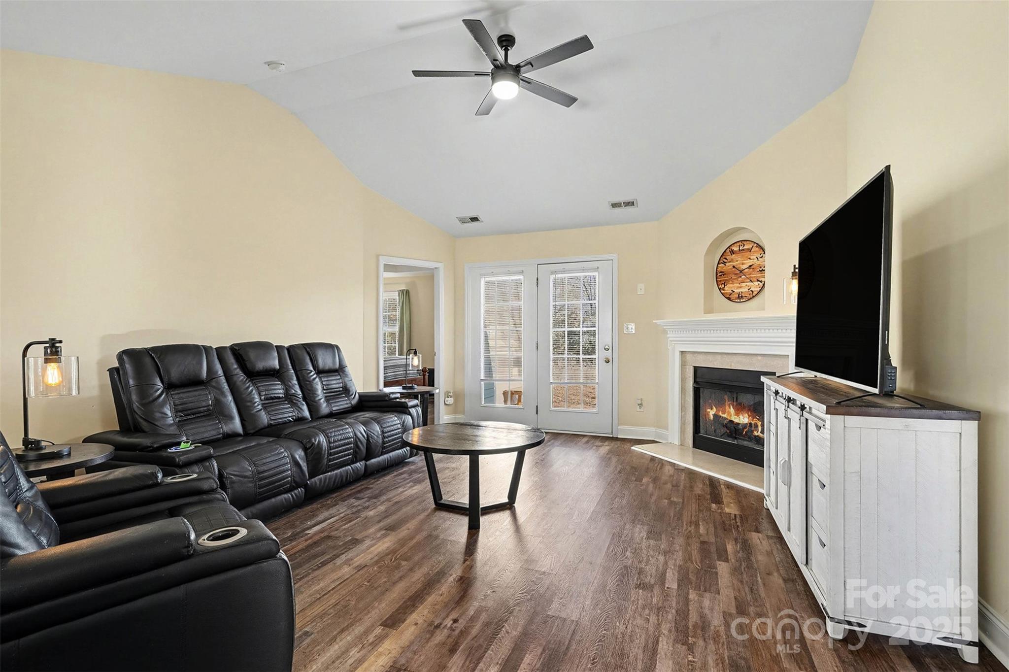 413 Dexter Place Monroe, NC 28110 - Photo 8 of 32 a living room with furniture a fireplace and a flat screen tv