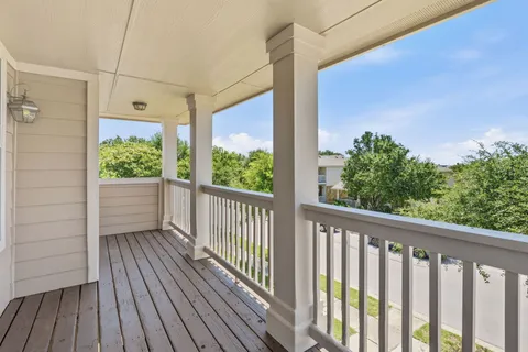 a view of a balcony with wooden floor