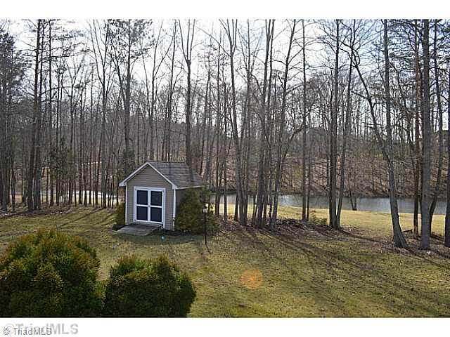 7083 Lanier Road Summerfield, NC 27358 - Photo 15 of 25 Exterior Back. Storage building in large backyard with another special view of the lake.