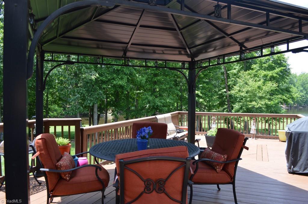 7083 Lanier Road Summerfield, NC 27358 - Photo 17 of 25 Deck leads to great flat backyard for entertaining and play.