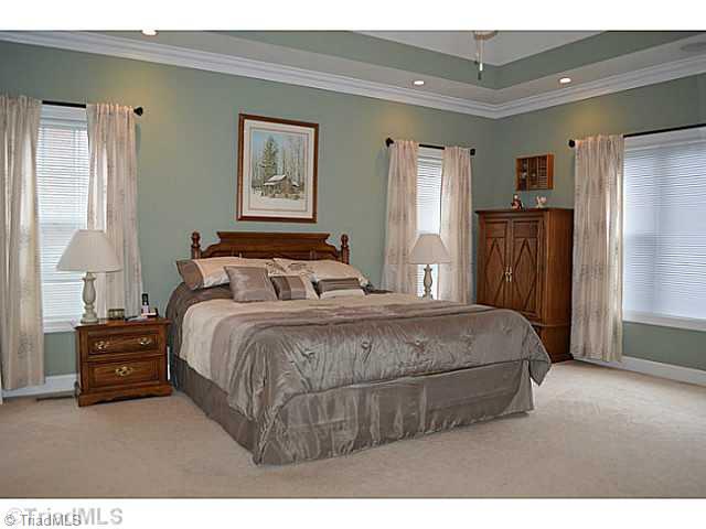 7083 Lanier Road Summerfield, NC 27358 - Photo 8 of 25 Master Bedroom. Main level master with vaulted ceiling, great views and doors leading to deck area for relaxing.