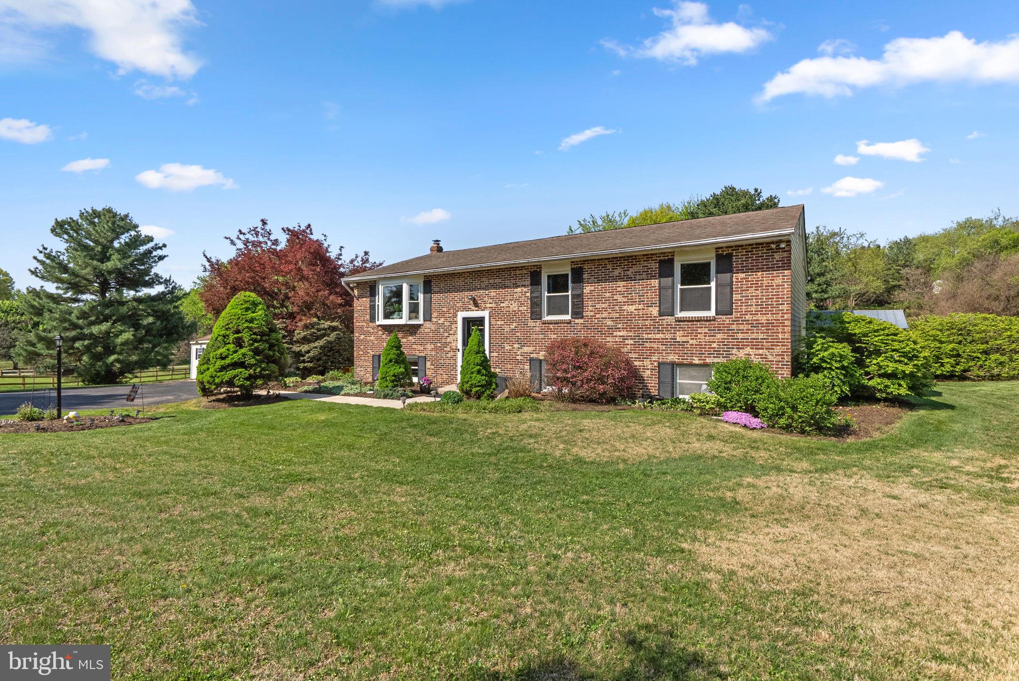 5140 Perry Road Mount Airy, MD 21771 - Photo 2 of 55 Charming brick home with lush greenery.