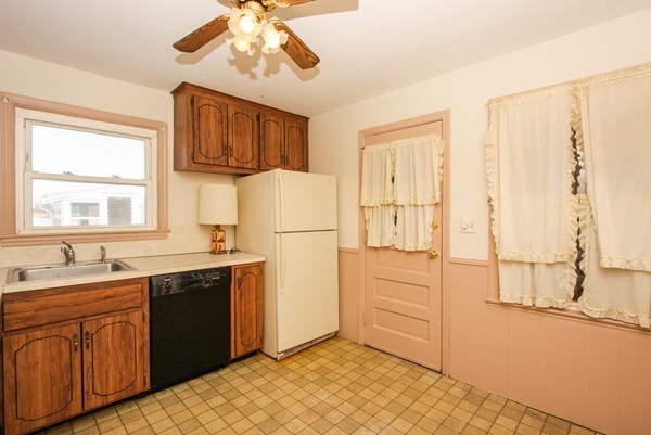 34 Surrey Road Springfield, MA 01118 - Photo 3 of 26 a kitchen with stainless steel appliances granite countertop a refrigerator a sink and white cabinets with wooden floor