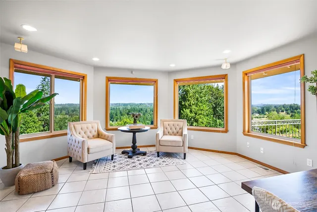 a living room with furniture and floor to ceiling windows