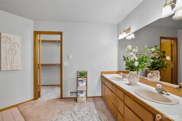 a bathroom with a granite countertop sink a mirror and a shower