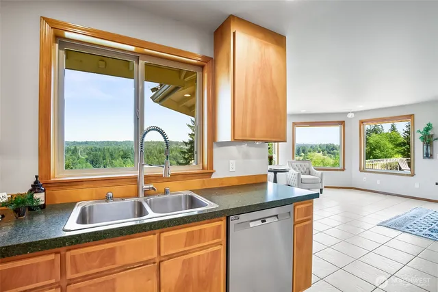 a kitchen that has a sink and a large window