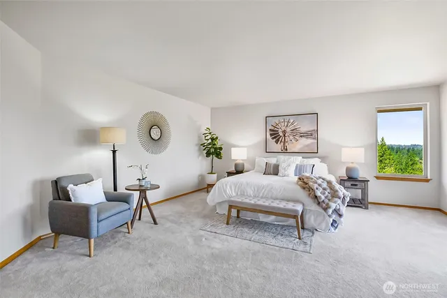 a bedroom with furniture and a large window