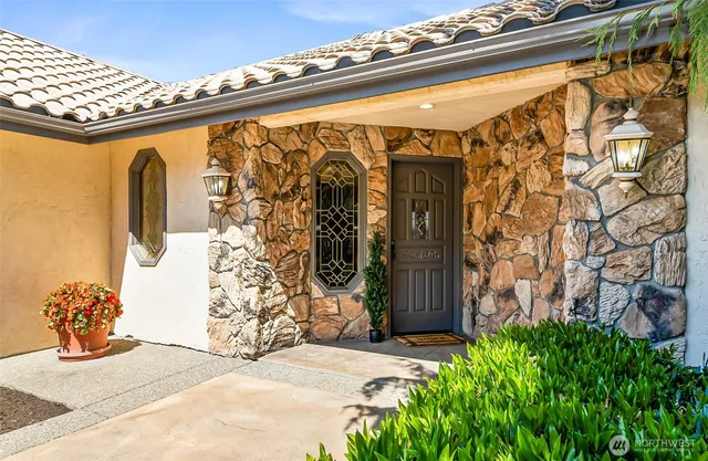 a view of a porch with potted plants