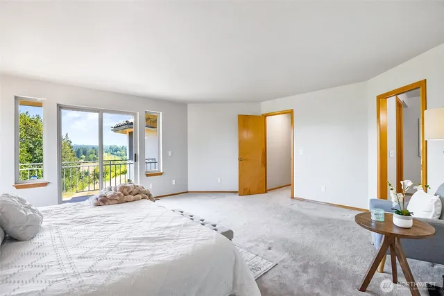 a spacious bedroom with a large bed and a large window