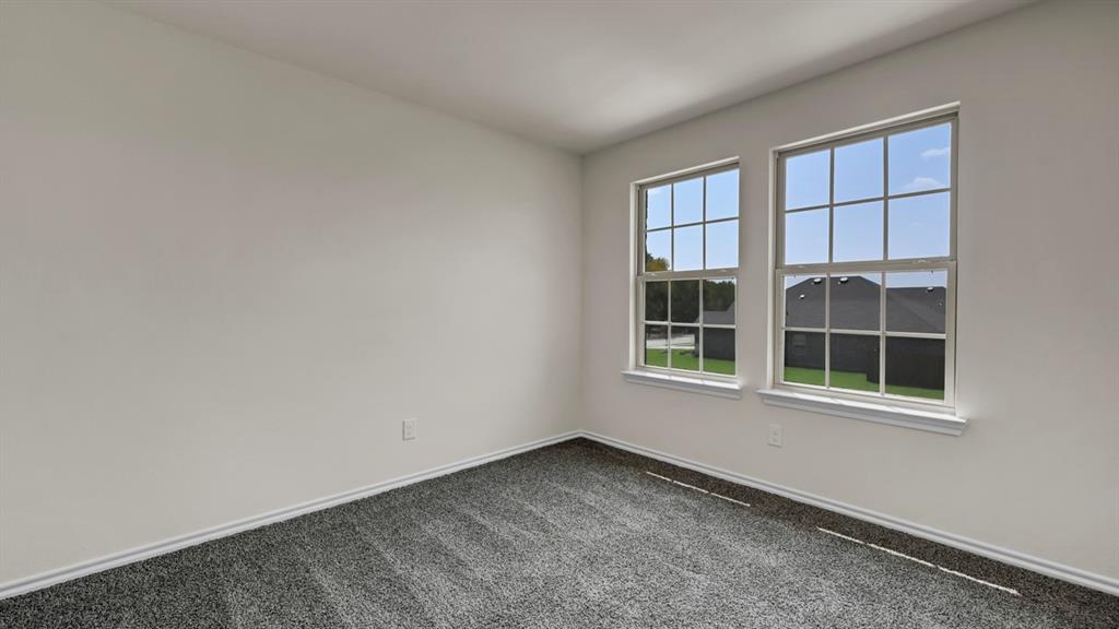4012 Ripplewood Drive Lindale, TX 75771 - Photo 10 of 37 Interior room featuring neutral wall paint, gray carpeting, and two multi-pane windows with white trim