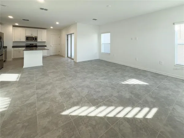 a view of a kitchen with a sink and cabinets