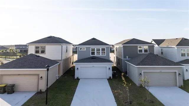 a front view of a house with a garden and parking space