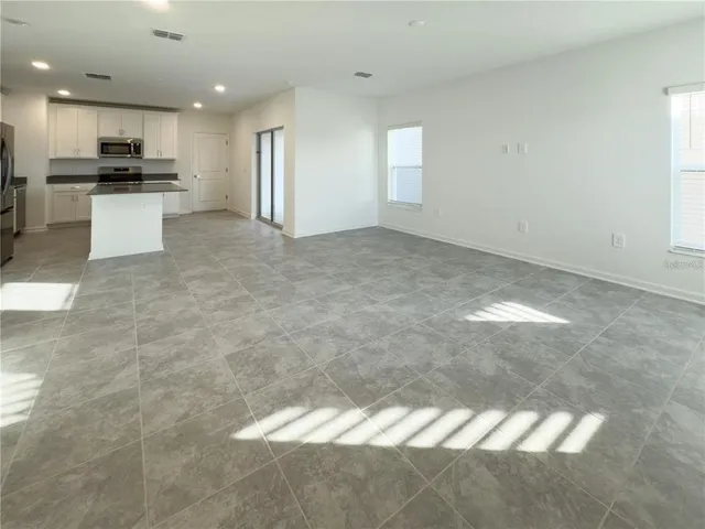 a view of a kitchen with a sink and cabinets