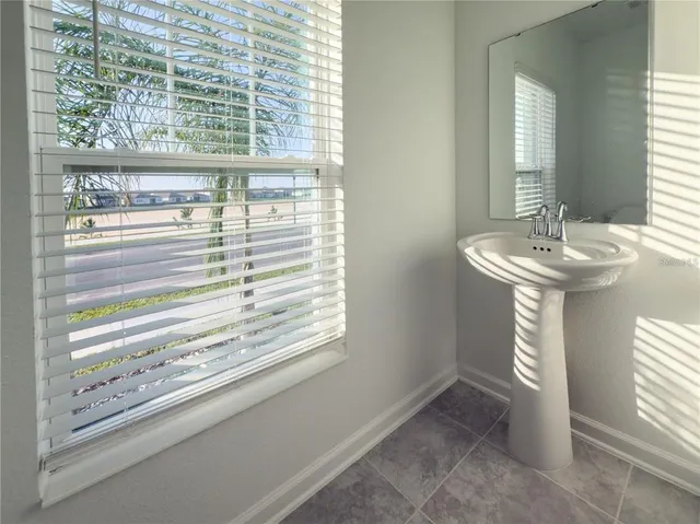 a bathroom with a sink and a window