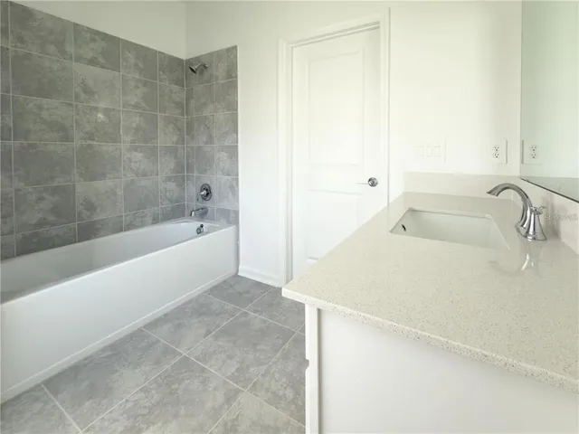 a bathroom with a tub sink and vanity