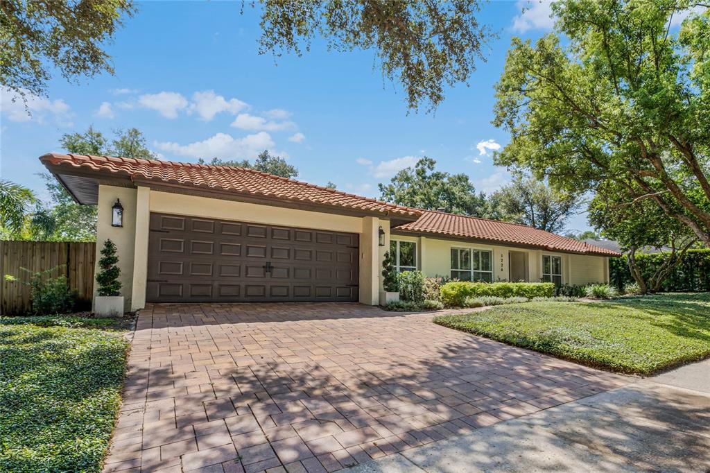 1226 Germaine Drive Winter Park, FL 32789 - Photo 1 of 45 a front view of a house with a yard and garage