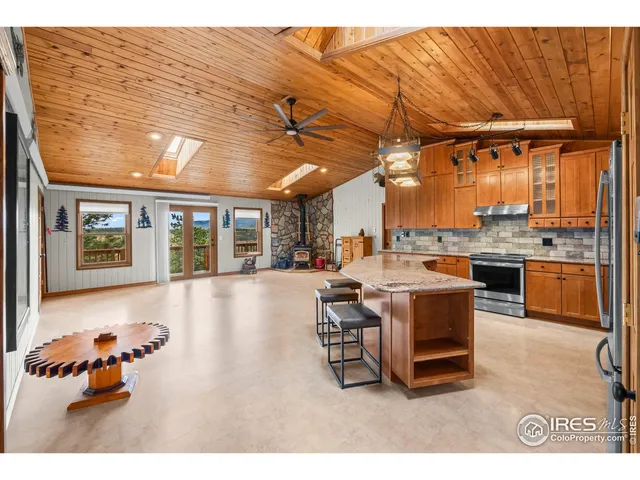 a dining room with furniture and a kitchen view