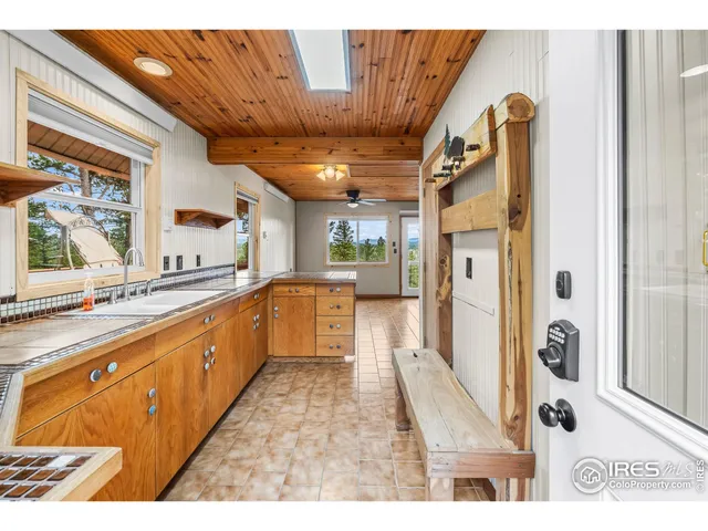 a large white kitchen with a large window