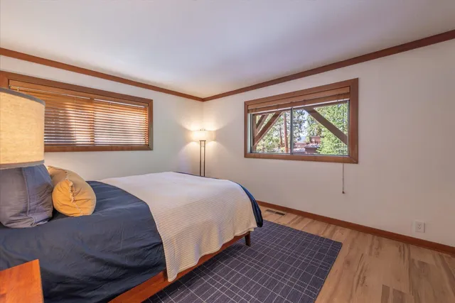 a bed room with a bed and a large window