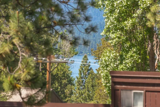 a bathroom with a granite countertop sink toilet mirror vanity and bathtub