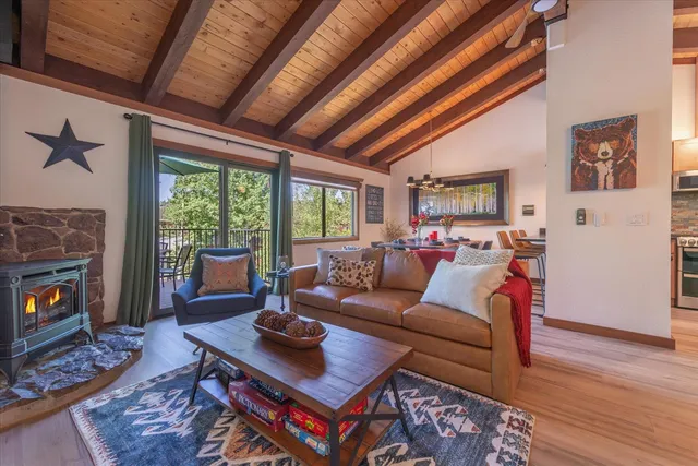 a living room with furniture a fireplace and a table