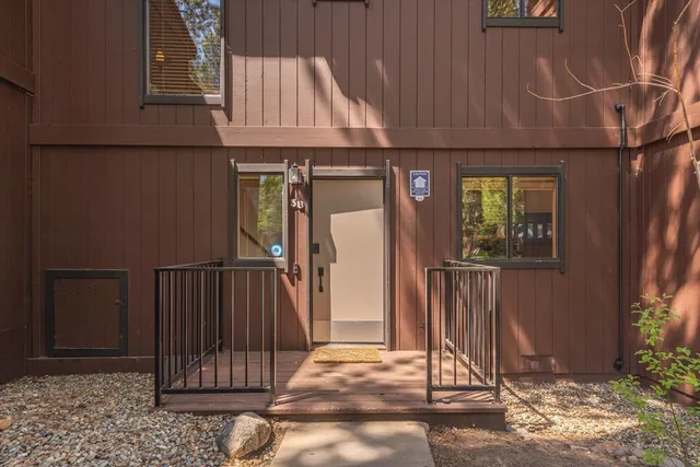 a view of a house with a door and wooden floor