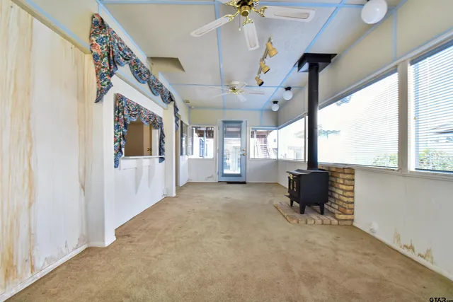 a view of livingroom with furniture workspace window and hardwood floor