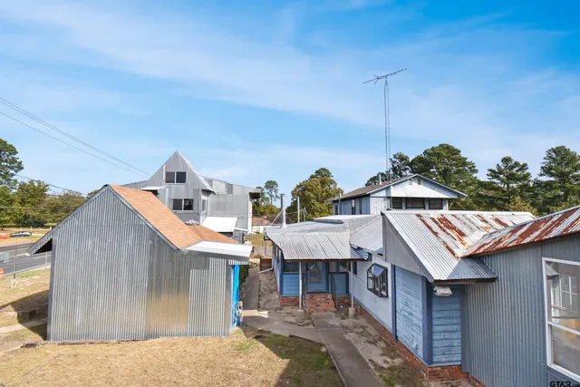 a roof deck with table and chairs