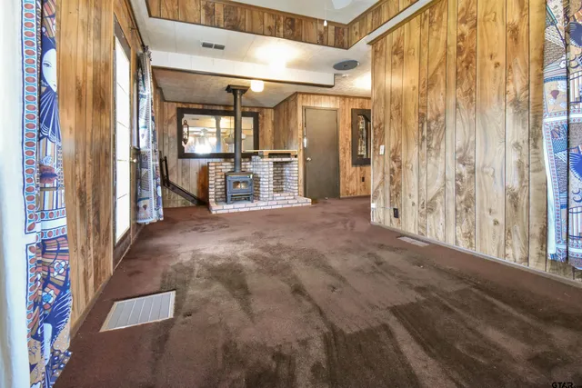 a view of a hallway with wooden shelves