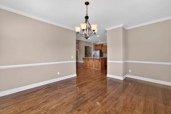 a view of a room with wooden floor