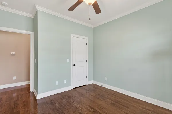 a view of an empty room with wooden floor