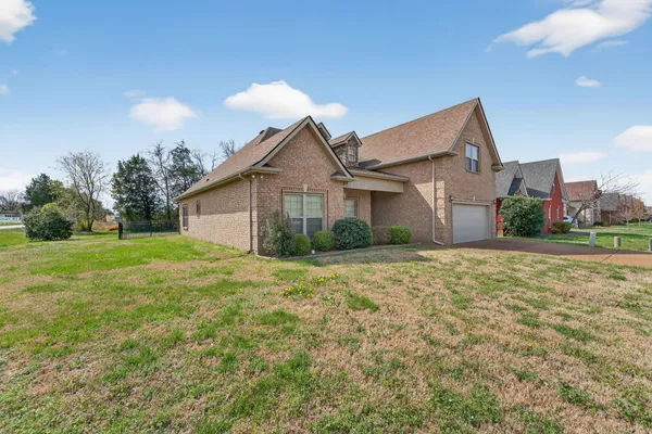 a view of a house with a yard and garage