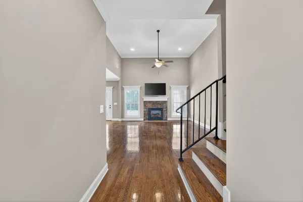 a view of entryway and hall with wooden floor