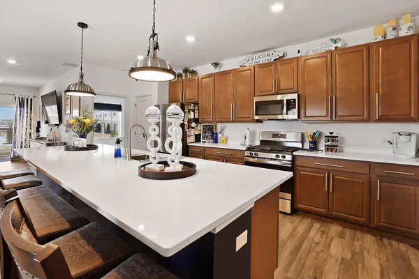 a kitchen with sink stove and microwave