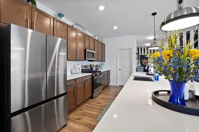a kitchen with counter top space stainless steel appliances and cabinets
